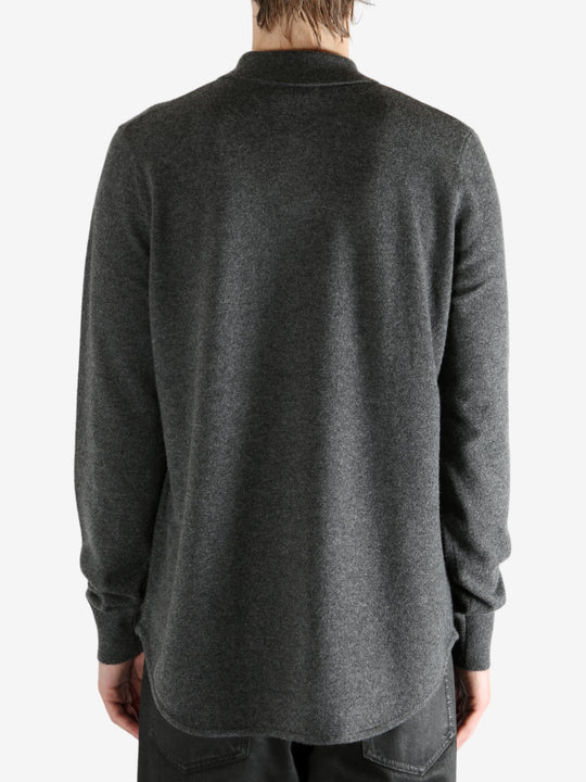 Grey shirt worn by a person, showing the shirt's fit