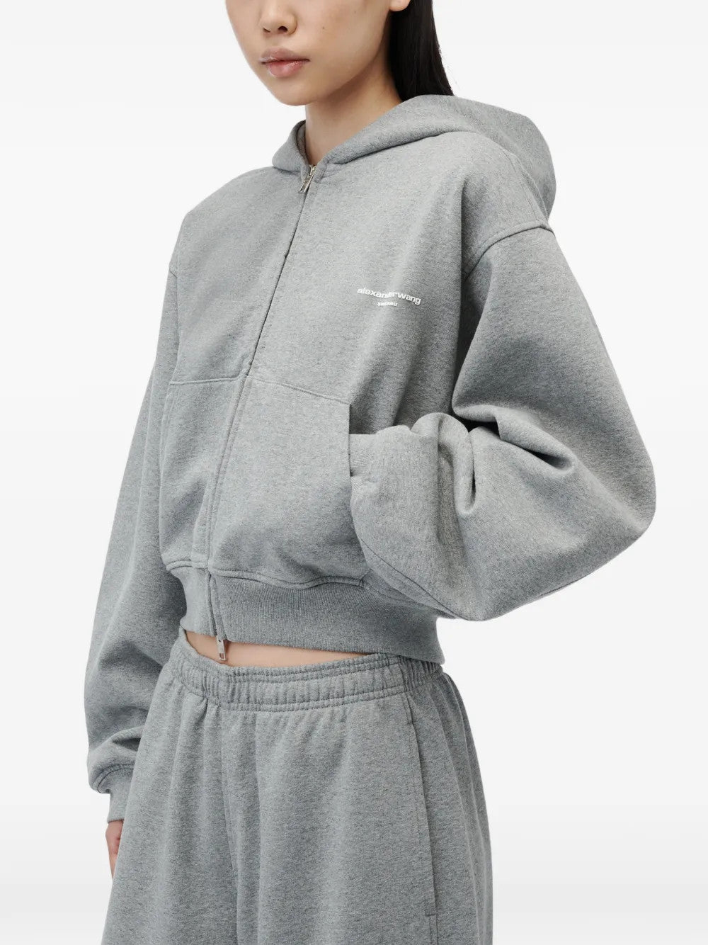 Grey hoodie worn by a person, showing the hoodie fit