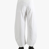 White pants worn by a person, showing the pants fit