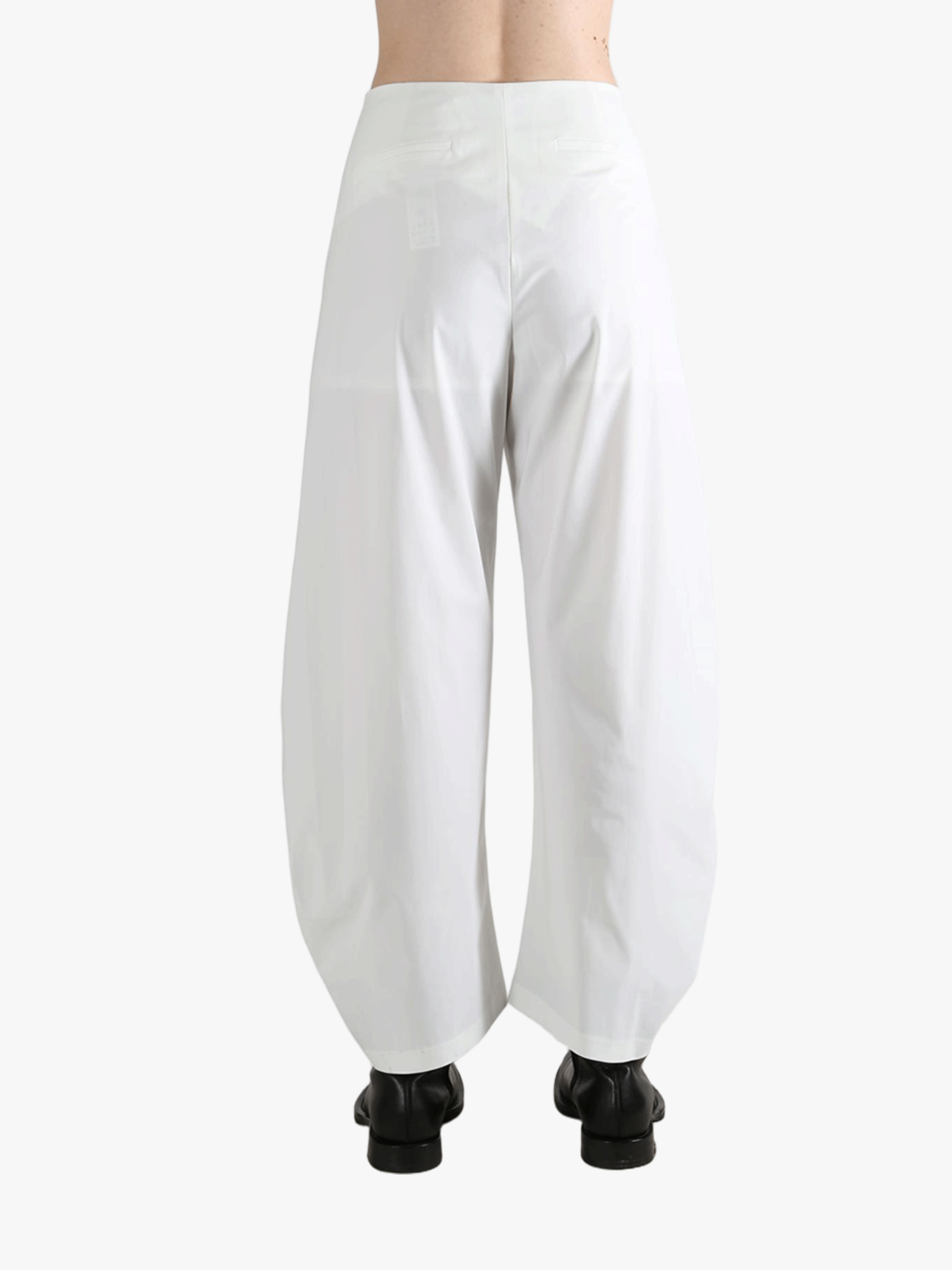 White pants worn by a person, showing the pants fit