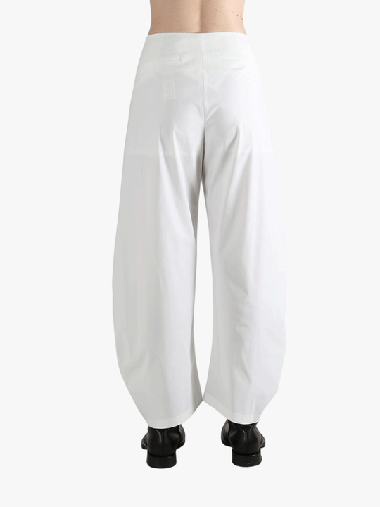 White pants worn by a person, showing the pants fit