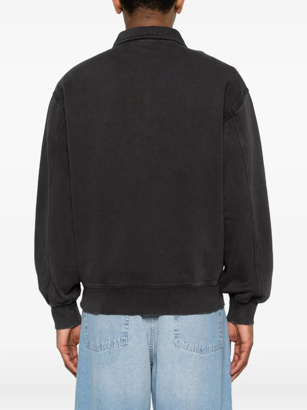 Black sweats worn by a person, showing the sweats' fit