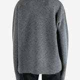 Grey knitwear worn by a person, showing the knitwear's fit