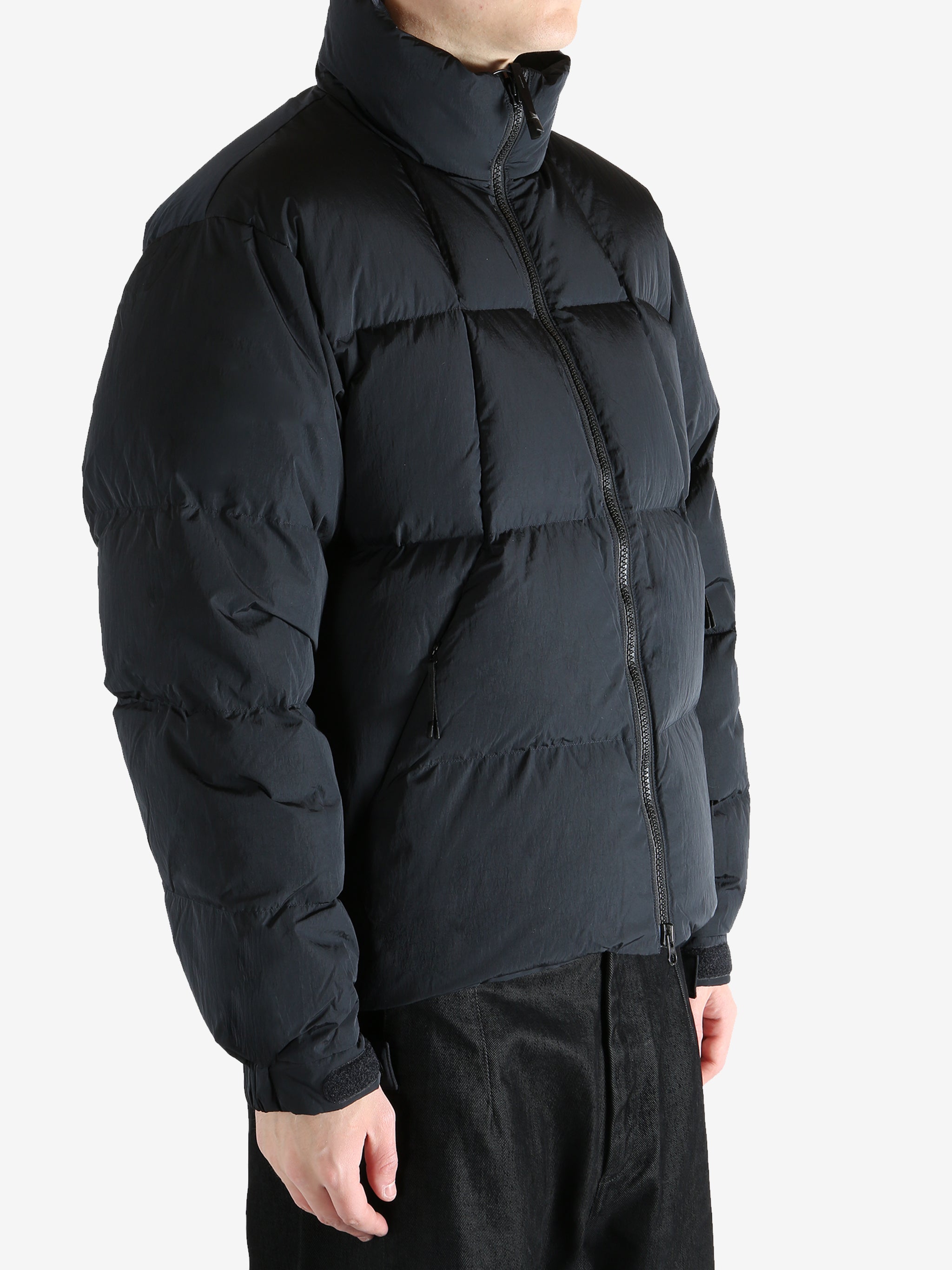 Black jacket worn by a person, showing the jacket fit