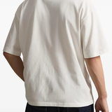 White t-shirt worn by a person, showing the t-shirt fit