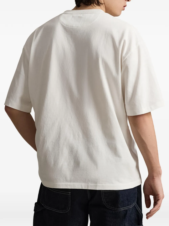 White t-shirt worn by a person, showing the t-shirt fit