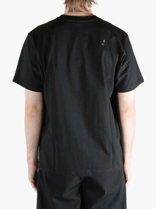 Black t-shirt worn by a person, showing the t-shirt's fit