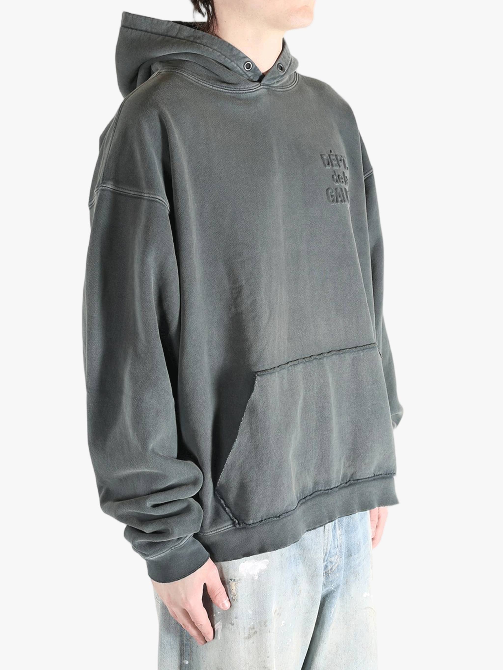 Grey hoodie worn by a person, showing the hoodie's fit