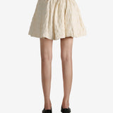 White skirt worn by a person, showing the skirt fit