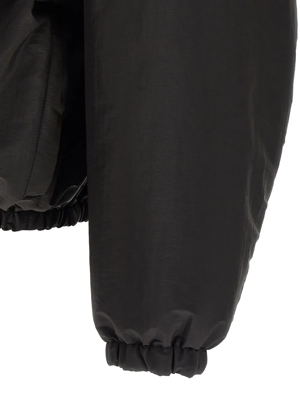 Close up of Black jacket, showing texture of the polyester fabric