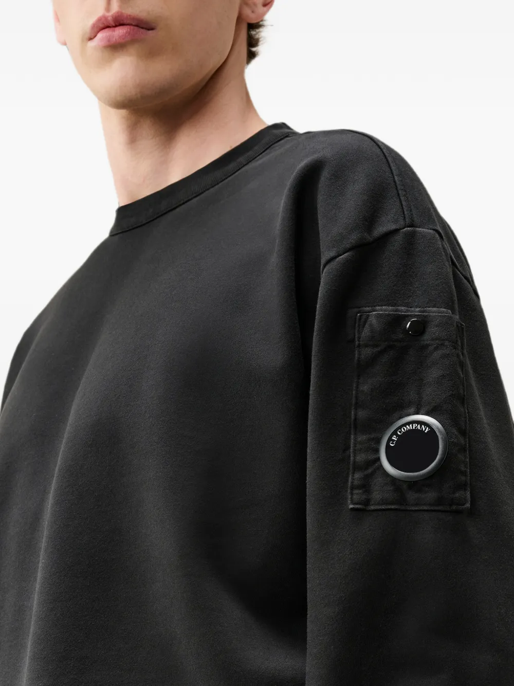 Black hoodie worn by a person, showing the hoodie fit