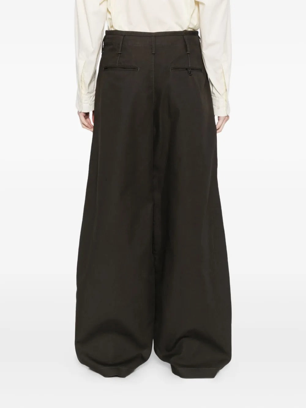 Black pants worn by a person, showing the pants' fit