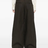 Black pants worn by a person, showing the pants' fit