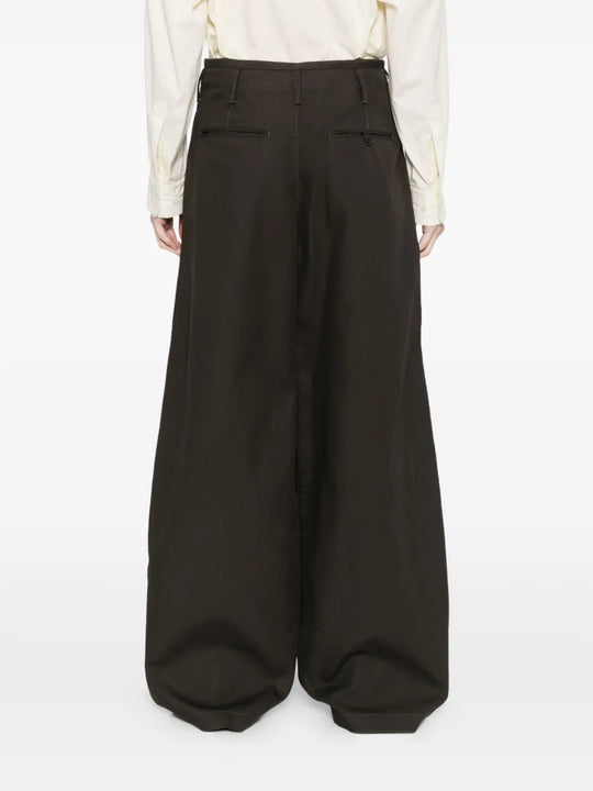 Black pants worn by a person, showing the pants' fit