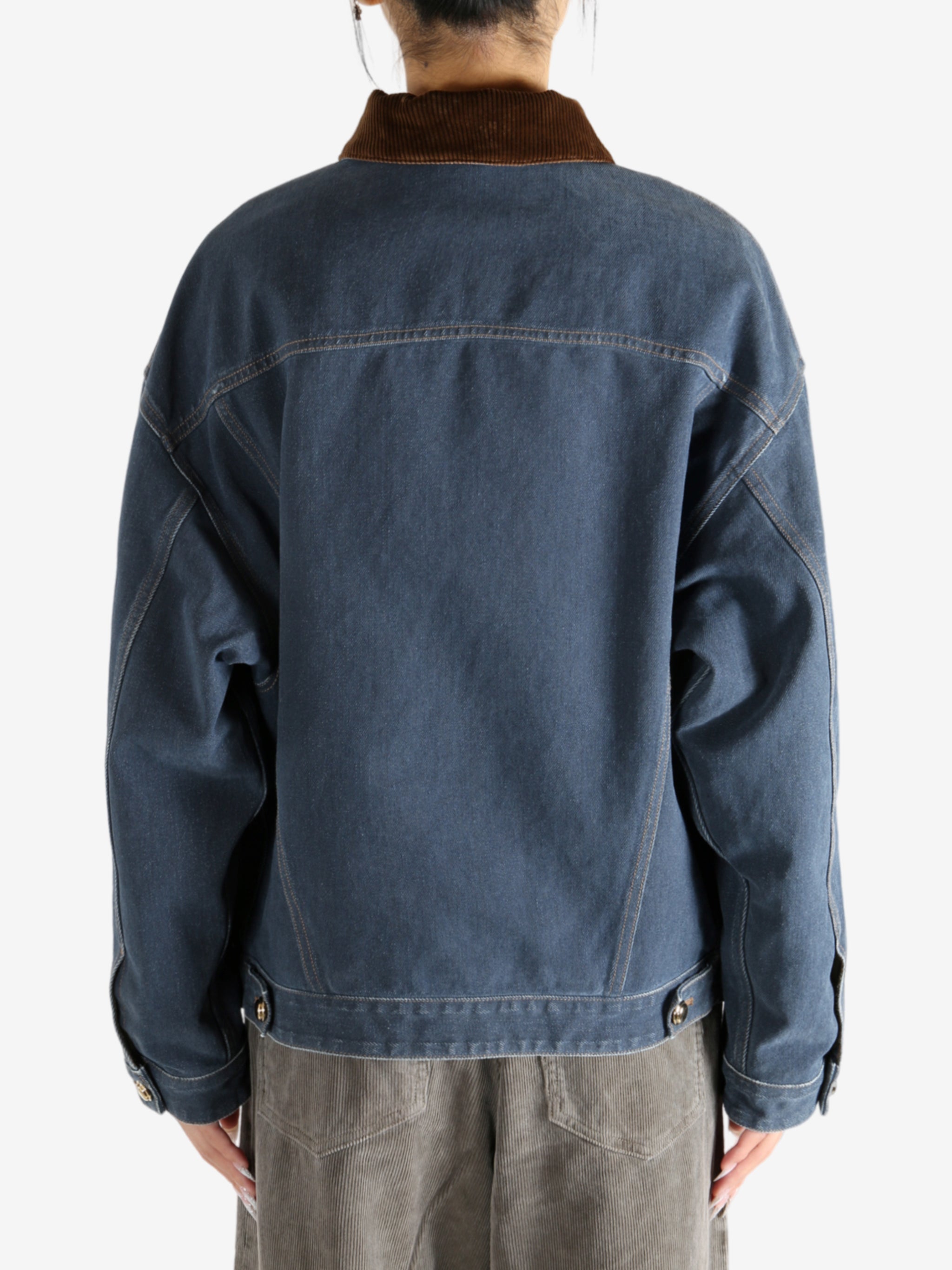 Blue jacket worn by a person, showing the jacket's fit