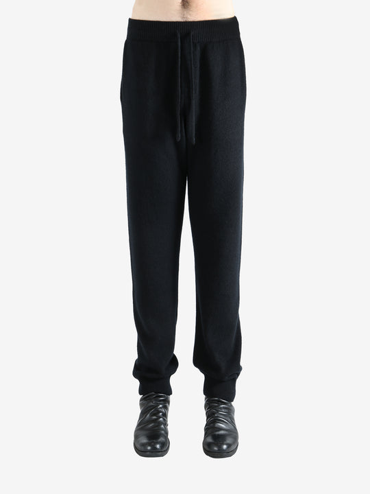 Black pants worn by a person, showing the pants' fit