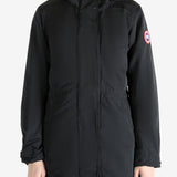 Black coat worn by a person, showing the coat fit