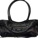 Close up of black bag, showing texture of the leather fabric