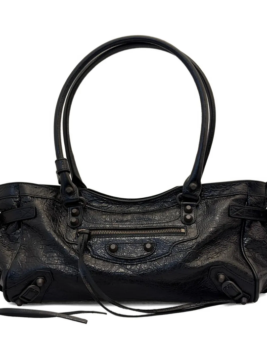 Close up of black bag, showing texture of the leather fabric