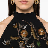 Black top worn by a person, showing the top fit