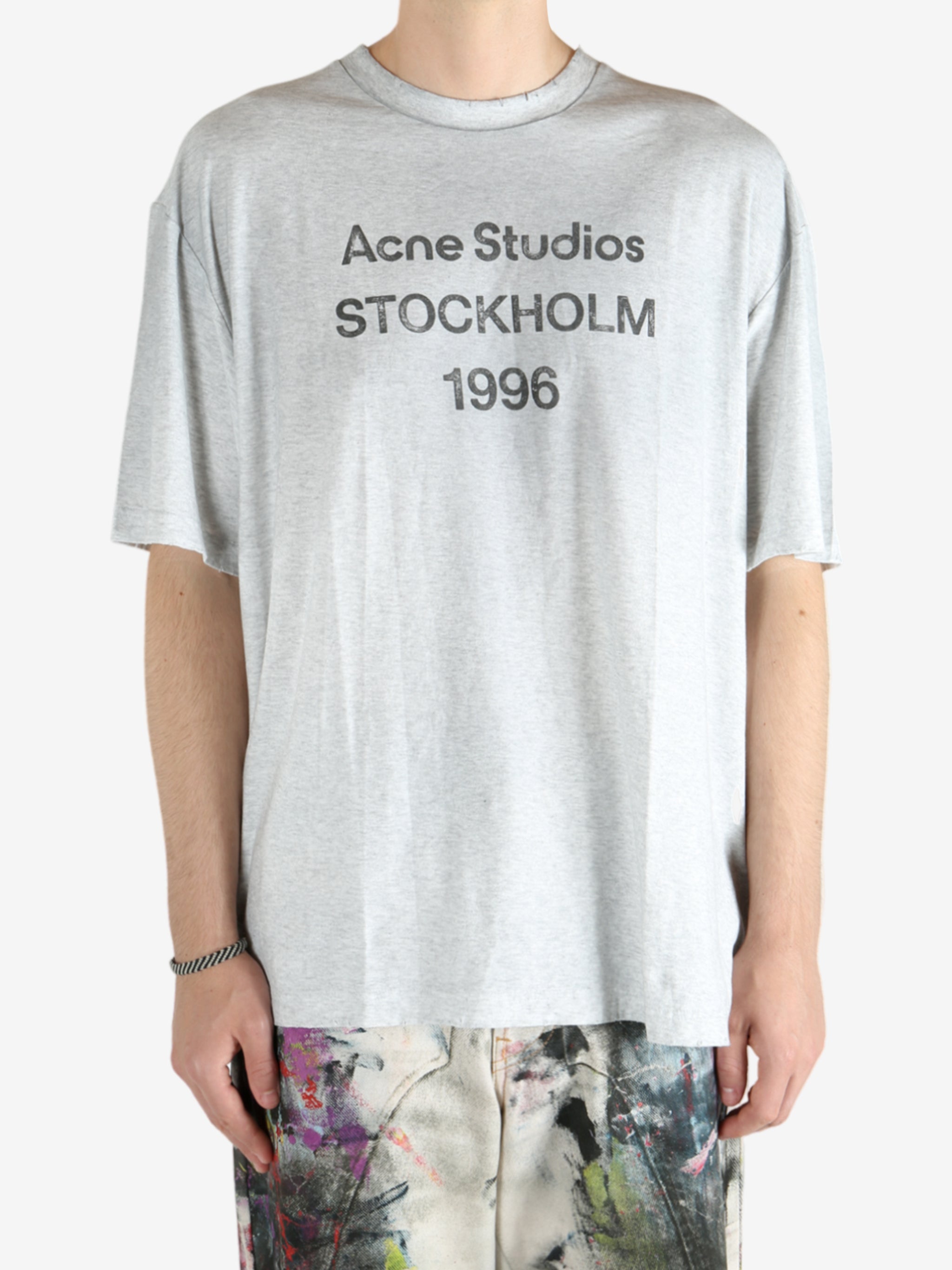 Grey t-shirt worn by a person, showing the shirt's fit