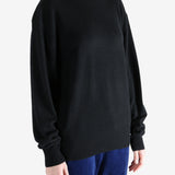 Black knitwear, worn by a person, showing the knitwear's fit
