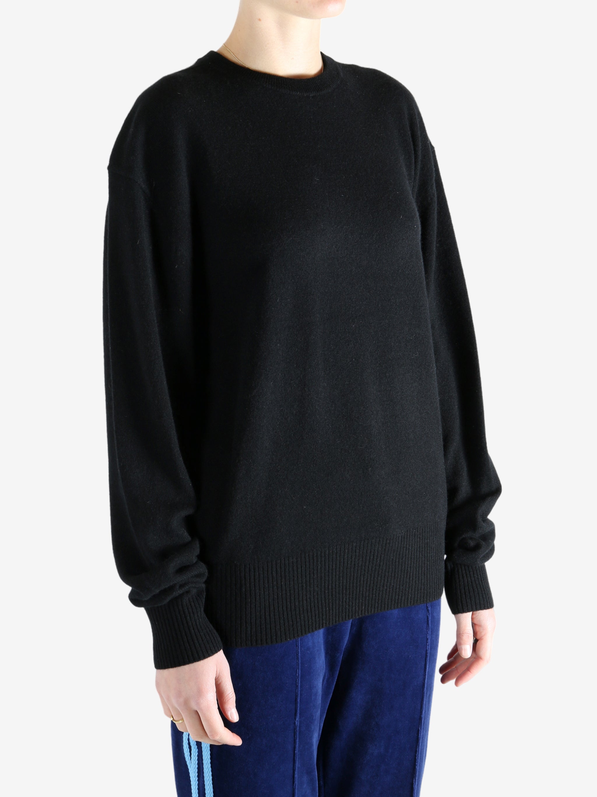 Black knitwear, worn by a person, showing the knitwear's fit