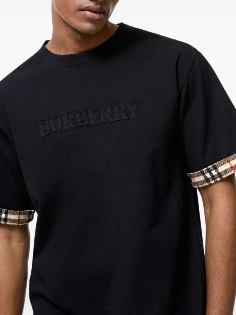 Black top worn by a person, showing the top fit