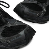 Close up of the black sneakers, showing texture of the polyester and polyurethane fabric