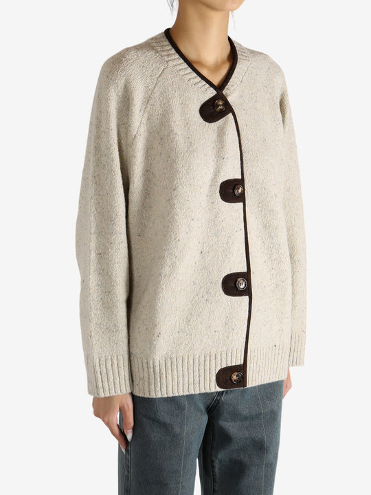 White knitwear worn by a person,showing the knitwear's fit