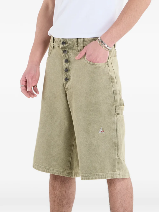 Green shorts worn by a person, showing the shorts fit