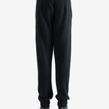 Black pants worn by a person, showing the pants' fit