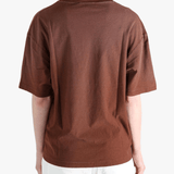 Brown t-shirt worn by a person, showing the t-shirt fit