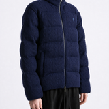 Navy knitwear worn by a person, showing the knitwear fit