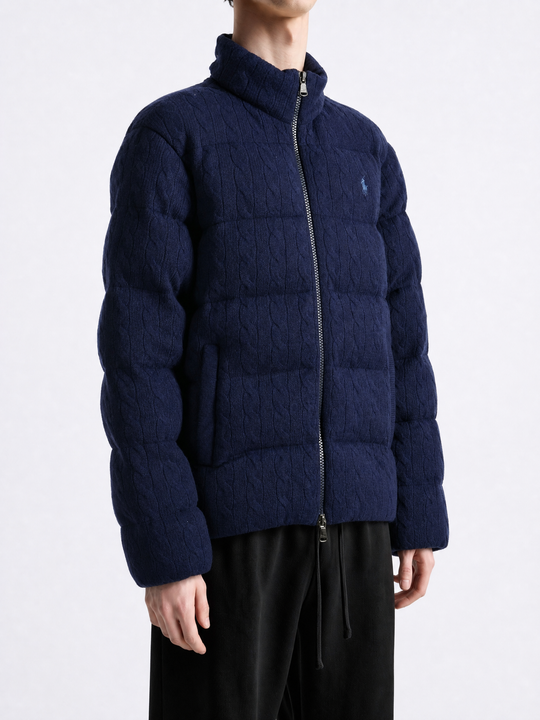 Navy knitwear worn by a person, showing the knitwear fit