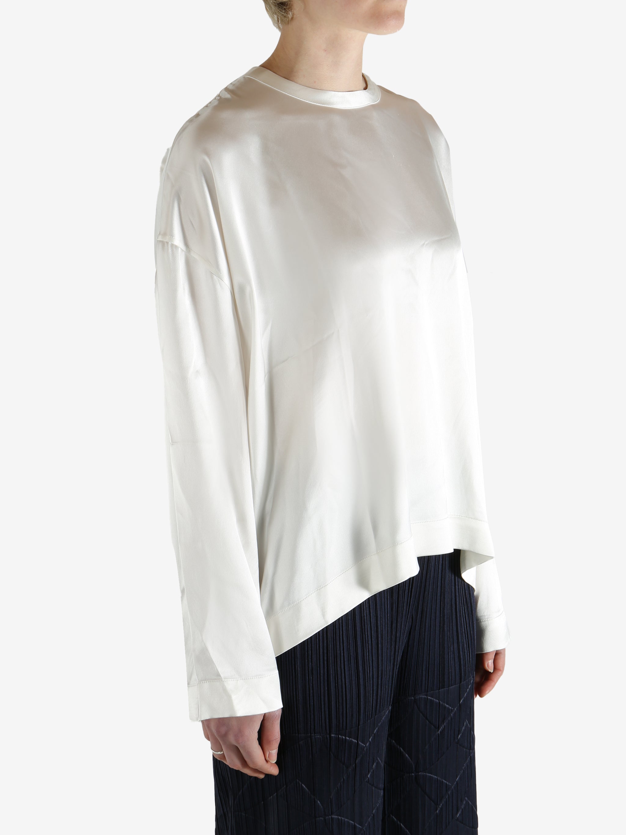 white long-sleeve shirt worn by a person, showing the shirt fit