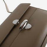 Close up of tan bag, showing texture of the leather fabric