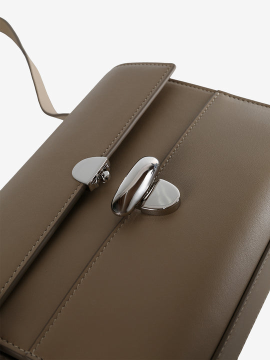 Close up of tan bag, showing texture of the leather fabric