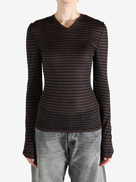 Brown top worn by a person, showing the top's fit