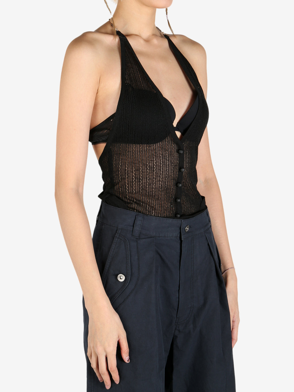 Black tops worn by a person, showing the tops fit