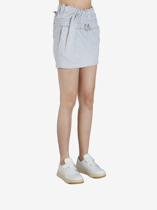 Grey skirt worn by a person, showing the skirt's fit