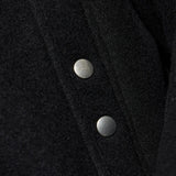 Close up of the black jacket, showing texture of the wool fabric