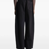 Black pants worn by a person, showing the pants fit