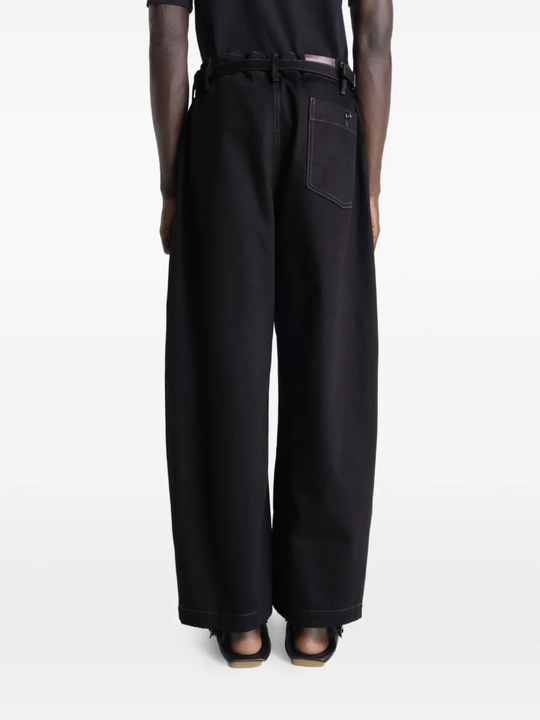 Black pants worn by a person, showing the pants fit