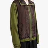 Green jacket worn by a person, showing the jacket fit