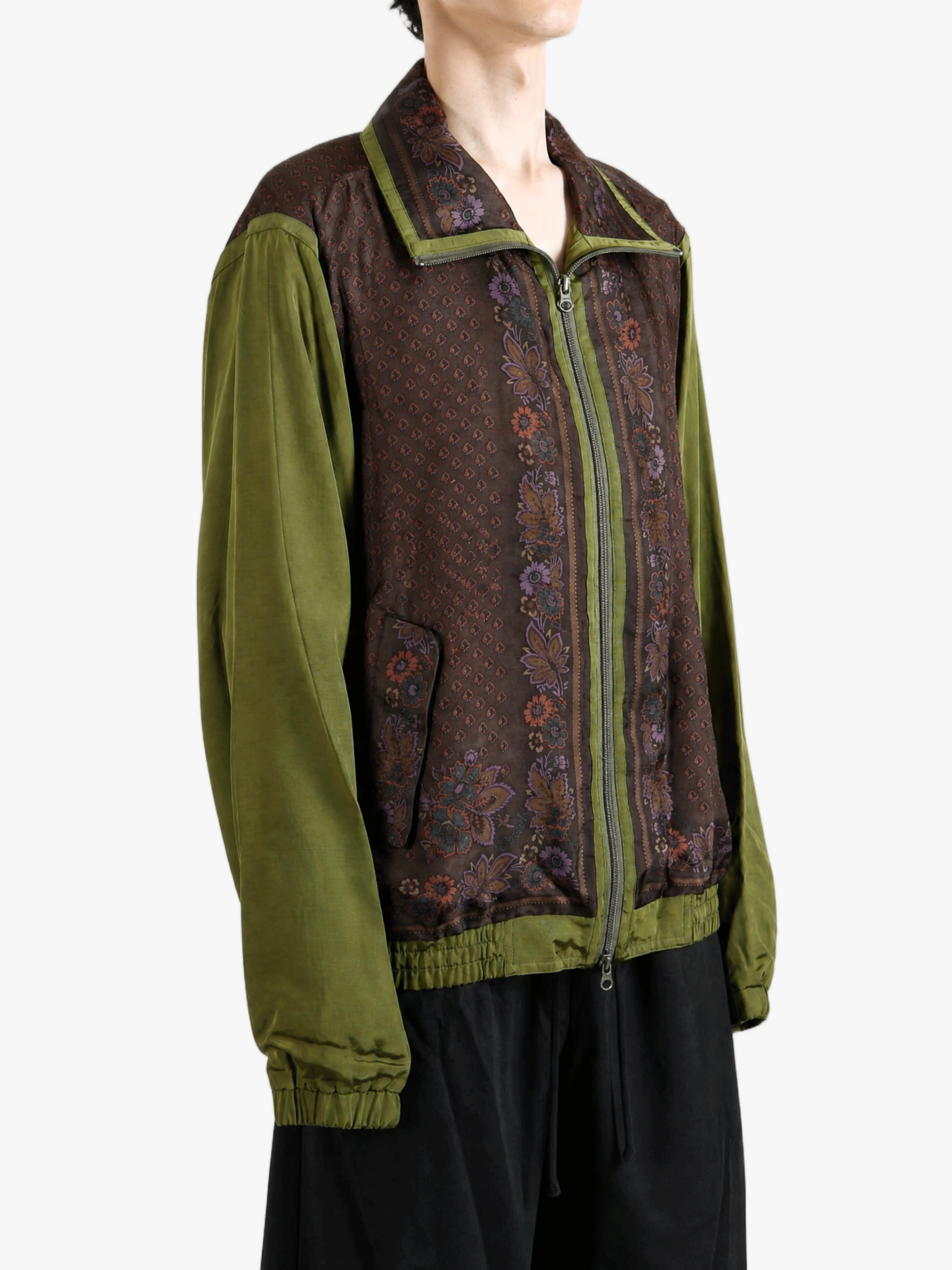 Green jacket worn by a person, showing the jacket fit