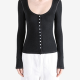 Black knitwear worn by a person, showing the knitwear fit