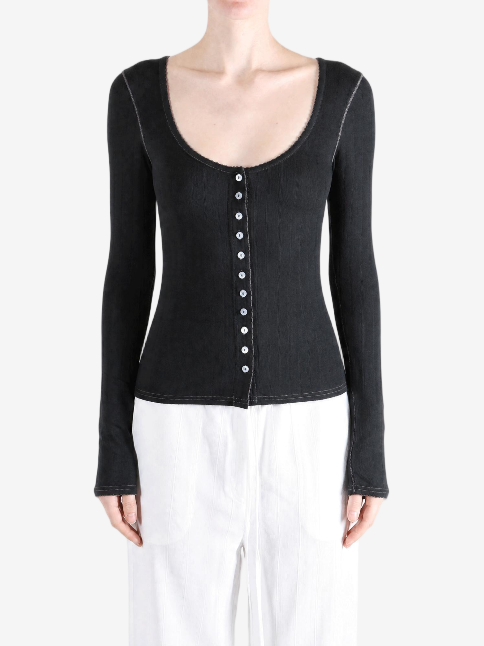 Black knitwear worn by a person, showing the knitwear fit