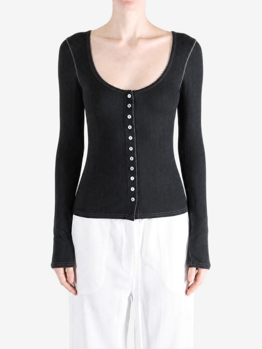 Black knitwear worn by a person, showing the knitwear fit