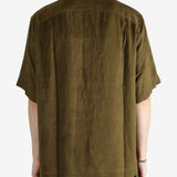 Green shirt worn by a person, showing the shirt's fit